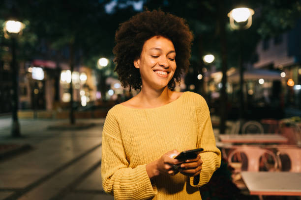 Young beautiful woman in city at night